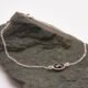 Sterling Silver Bezel-set Garnet Bracelet shown on dark grey stone