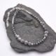 Grey Banded Agate and Hematite Sterling Silver Bracelet shown on grey stone