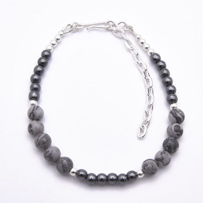 Grey Banded Agate and Hematite Sterling Silver Bracelet viewed from above on flat white surface