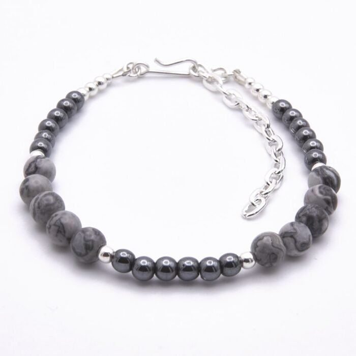 Grey Banded Agate and Hematite Sterling Silver Bracelet shown on flat white surface