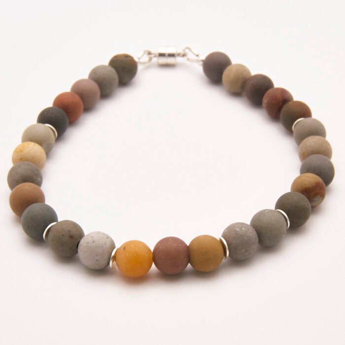Natural Frosted Ocean Jasper and Sterling Silver Bracelet shown on flat white surface