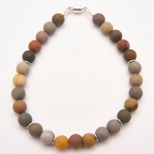 Natural Frosted Ocean Jasper and Sterling Silver Bracelet with Magnetic Clasp shown from above on flat white surface