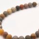 Natural Frosted Ocean Jasper and Sterling Silver Bracelet close up of beads on flat white surface