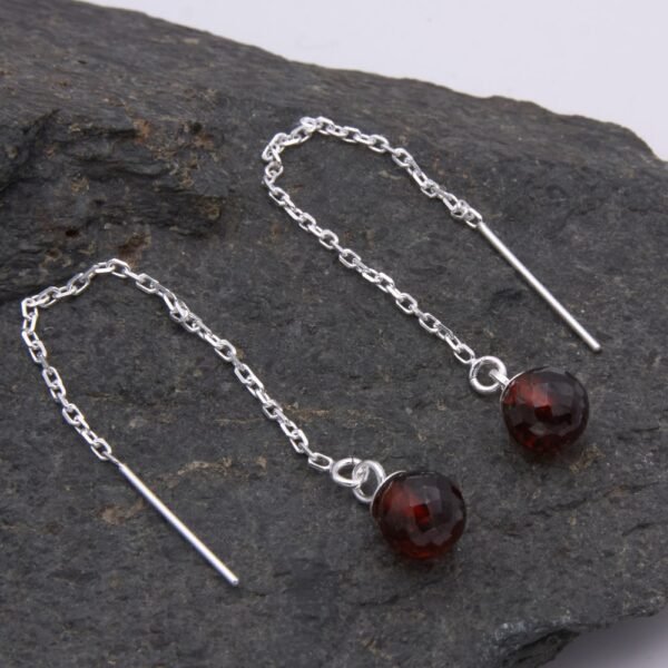 Garnet and Sterling Silver Threader Earrings on rock