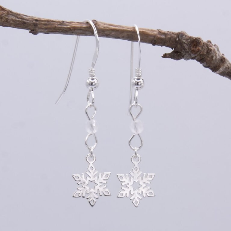 Snowflake and Rainbow Moonstone Sterling Silver Earrings hanging from twig