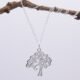 Tree Charm Sterling Silver Necklace hanging from twig