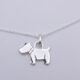Dog Charm Sterling Silver Necklace shown close up on flat white surface