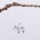 Dog Charm Sterling Silver Necklace shown close up hanging from twig
