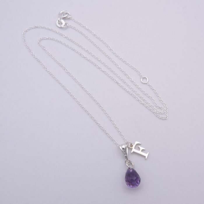 Amethyst Teardrop Pendant Necklace with additional Initial Charm shown on flat white surface