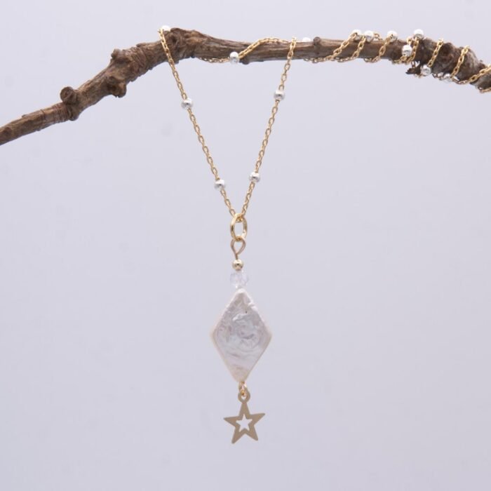 Diamond Shaped Freshwater Pearl and Gold Filled Star Necklace hanging from twig