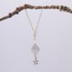 Diamond Shaped Freshwater Pearl and Gold Filled Star Necklace hanging from twig