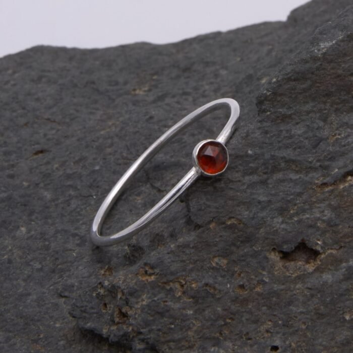 Garnet Sterling Silver Slimline Ring 1 Garnet Sterling Silver Slimline Ring on rock