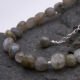 Labradorite Smooth Chip Bead Sterling Silver Bracelet with extender chain with wire-wrapped bead decoration, close up shown on dark grey stone
