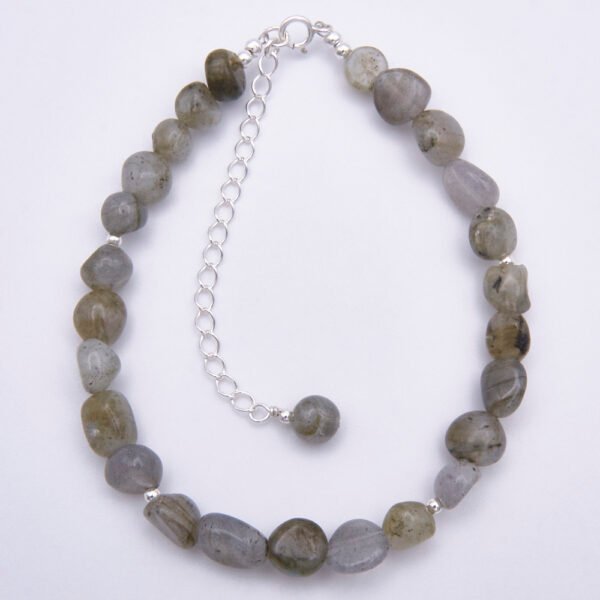 Labradorite Smooth Chip Bead Sterling Silver Bracelet with extender chain with wire-wrapped bead decoration, shown viewed from above on a plain white surface