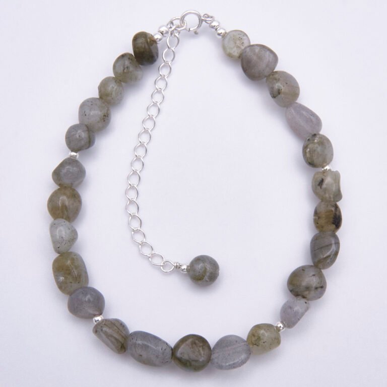 Labradorite Smooth Chip Bead Sterling Silver Bracelet with extender chain with wire-wrapped bead decoration, shown viewed from above on a plain white surface