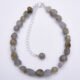 Labradorite Smooth Chip Bead Sterling Silver Bracelet with extender chain with wire-wrapped bead decoration, shown viewed from above on a plain white surface
