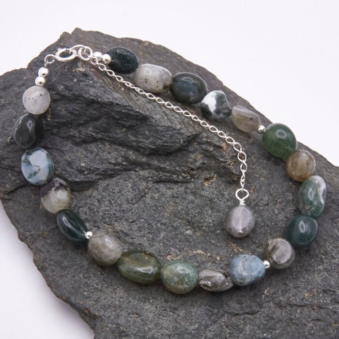 Moss Agate and Labradorite Bracelet shown on dark grey stone