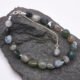 Moss Agate and Labradorite Bracelet shown on dark grey stone