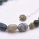 Moss Agate and Labradorite Sterling Silver Bracelet close up of beads on flat white surface
