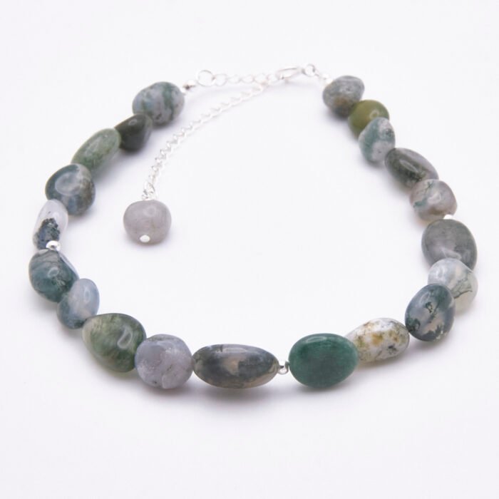 Moss Agate Sterling Silver Bracelet with Extender Chain and wire-wrapped Labradorite bead trim shown on flat whhite surface viewed from front to back