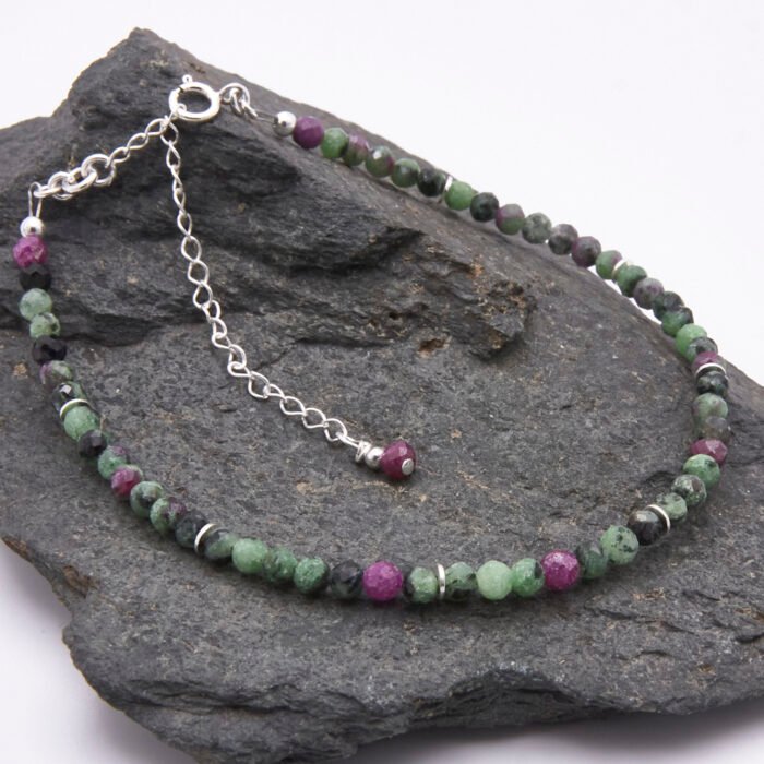 Ruby Zoisite Sterling Silver Bracelet with faceted round Ruby Zoisite beads interspersed with sterling silver flat spacers and finished with a sterling silver spring ring clasp and extender chain with ruby bead trim