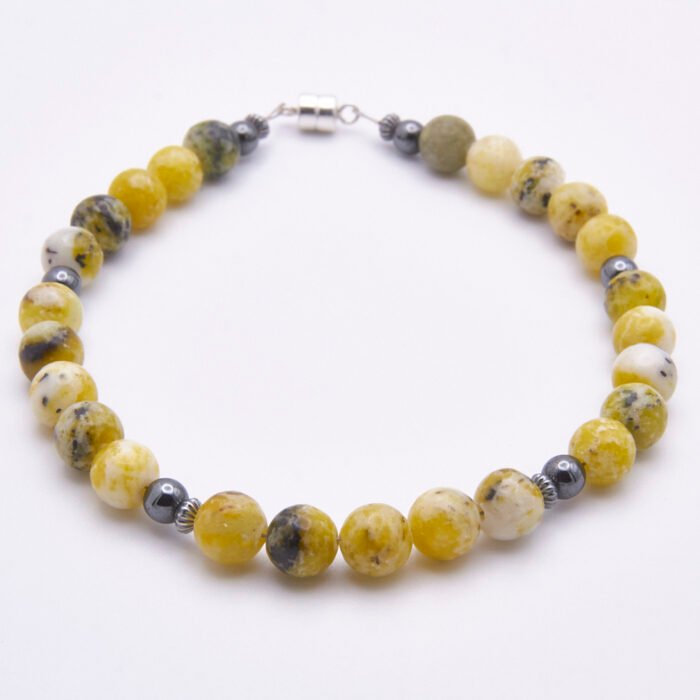 Yellow Turquoise and Hematite Sterling Silver Bracelet with Magnetic Clasp angled view on flat surface