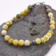 Yellow Turquoise and Hematite Sterling Silver Bracelet with Magnetic Clasp shown on dark grey stone