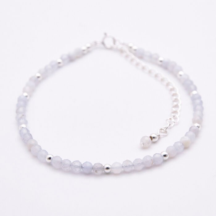 Blue Lace Agate and Sterling Silver Bracelet shown laid flat on a white surface