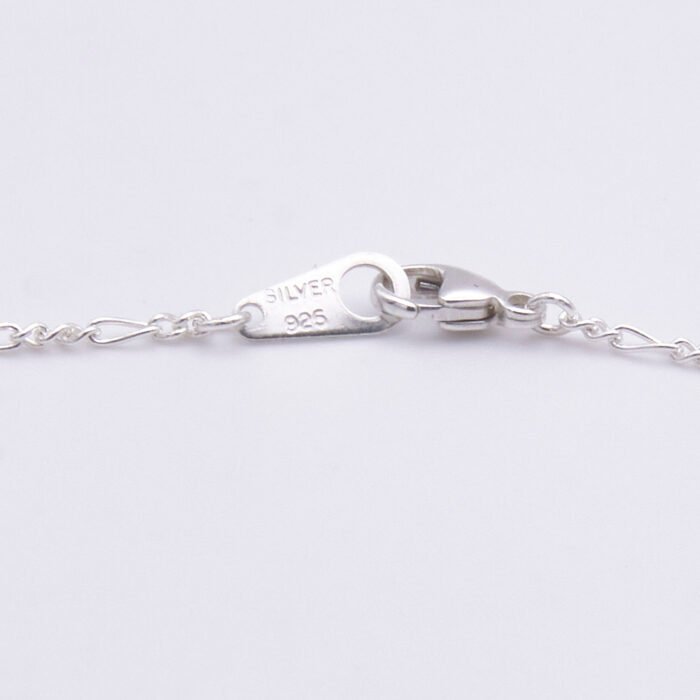 Sterling Silver Bezel-Set Green Onyx Bracelet close up of clasp and tag on flat white surface