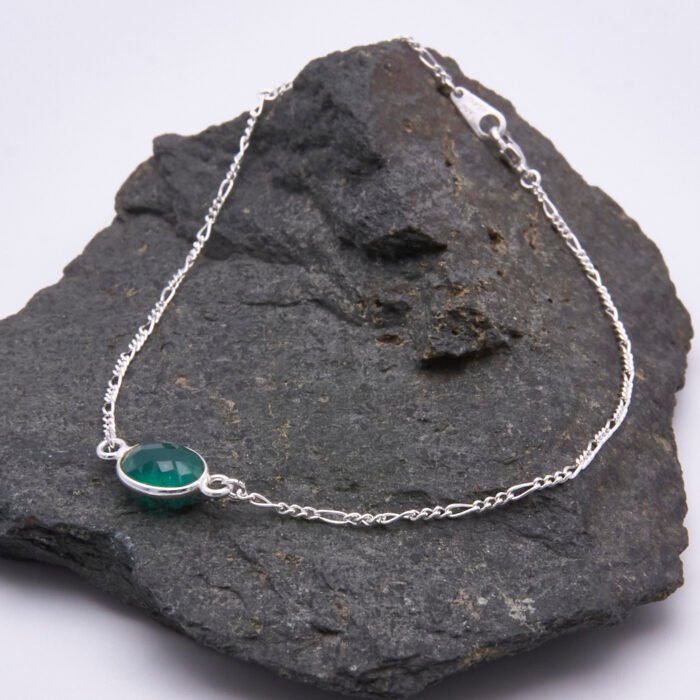 Sterling Silver Bezel-Set Green Onyx Bracelet shown laid flat on dark grey stone