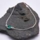 Sterling Silver Bezel-Set Green Onyx Bracelet shown laid flat on dark grey stone