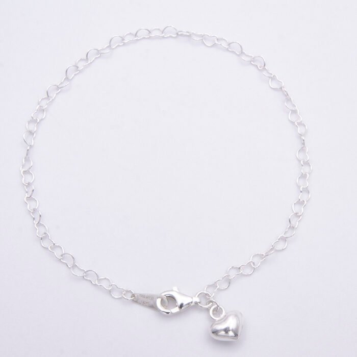 Sterling Silver Heart Link Chain Bracelet with Puffy Heart Charm viewed from above on flat white surface Sterling Silver Heart Link Chain Bracelet with Puffy Heart Charm viewed from above on flat white surface