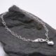 Sterling Silver Heart Link Chain Bracelet with Puffy Heart Charm Sterling Silver Heart Link Chain Bracelet with single puffy style Sterling Silver Heart Charm fixed close to lobster clasp, shown on grey stone