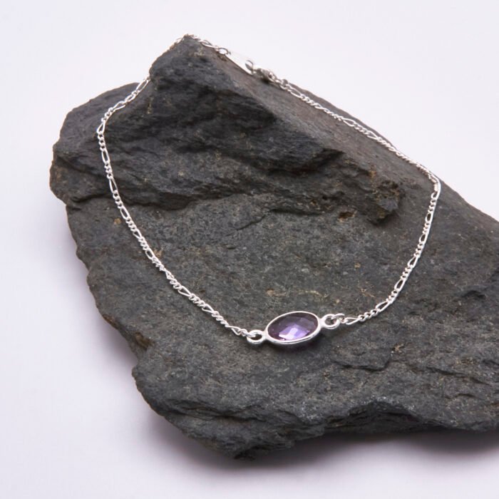 Sterling Silver Bezel-set Amethyst Bracelet shown on grey stone