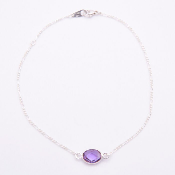 Sterling Silver Bezel-set Amethyst Bracelet with Figaro chain shown from above on flat white surface