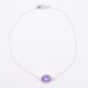 Sterling Silver Bezel-set Amethyst Bracelet with Figaro chain shown from above on flat white surface