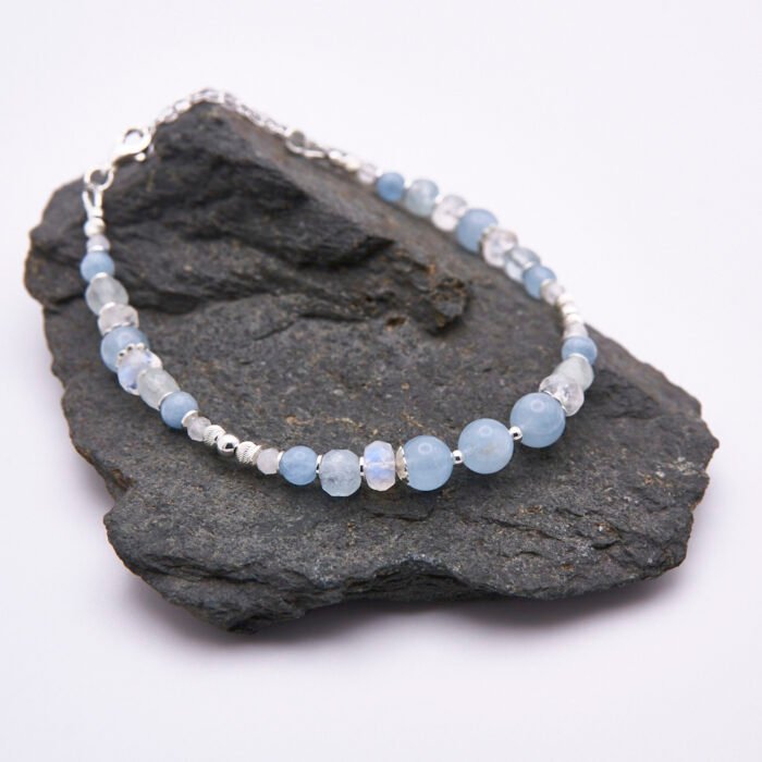 Aquamarine and Rainbow Moonstone Sterling Silver Bracelet shown on dark grey stone