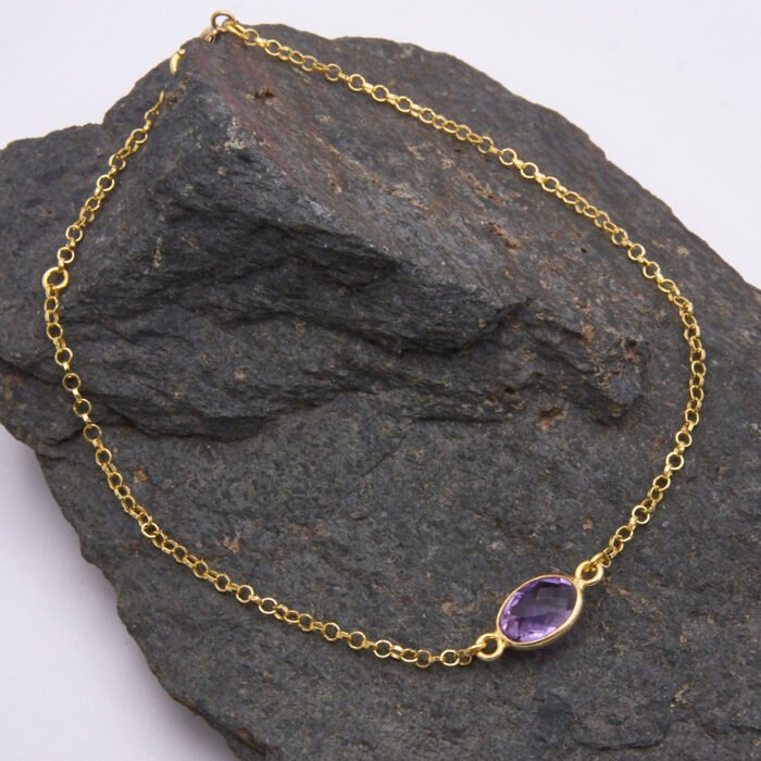 Amethyst 24k Gold Plated Sterling Silver Bracelet shown on dark grey stone