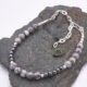 Grey Banded Agate and Hematite Sterling Silver Bracelet with extender chain shown on dark grey stone