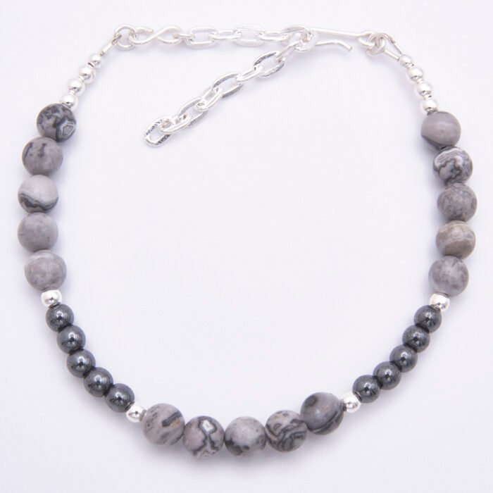 Grey Banded Agate and Hematite Sterling Silver Bracelet with extender chain shown from above on plain white surface