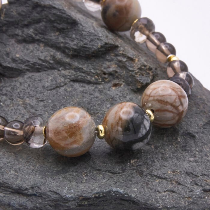 Picasso Jasper, Smoky Quartz and Watermelon Quartz Bracelet close up of Picasso Jasper beads on dark grey stone