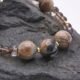 Picasso Jasper, Smoky Quartz and Watermelon Quartz Bracelet close up of Picasso Jasper beads on dark grey stone
