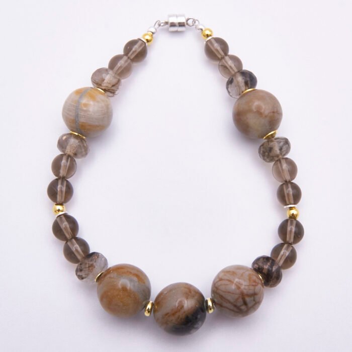Picasso Jasper, Smoky Quartz and Smoky Watermelon Quartz Mixed Metals Bracelet with magnetic clasp shown top down on plain white surface