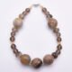 Picasso Jasper, Smoky Quartz and Smoky Watermelon Quartz Mixed Metals Bracelet with magnetic clasp shown top down on plain white surface