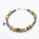 Yellow Turquoise and Hematite Bracelet with Lobster Clasp and Extender Chain on flat white surface