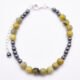 Yellow Turquoise and Hematite Bracelet with Lobster Clasp and Extender Chain with Hematite bead decoration shown from above on flat white surface