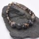 Picasso Jasper, Smoky Quartz and Smoky Watermelon Quartz Mixed Metals Bracelet with magnetic clasp shown laid flat on a dark grey stone