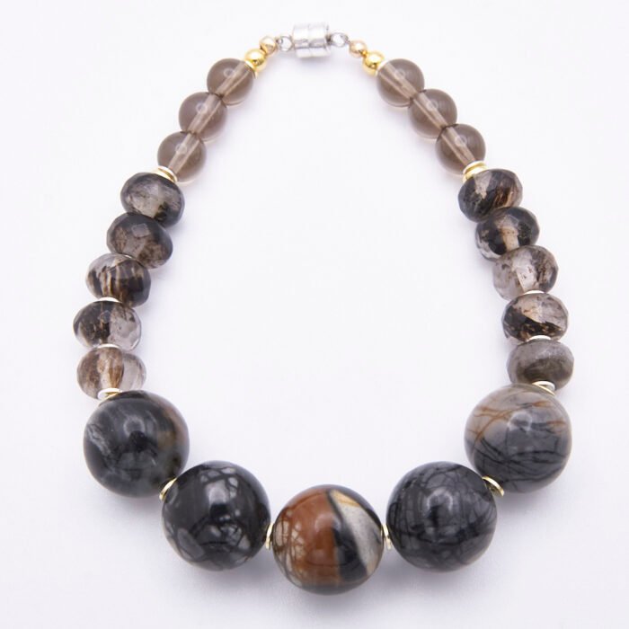 Picasso Jasper, Smoky Quartz and Smoky Watermelon Quartz Mixed Metals Bracelet with magnetic clasp top down on plain white surface