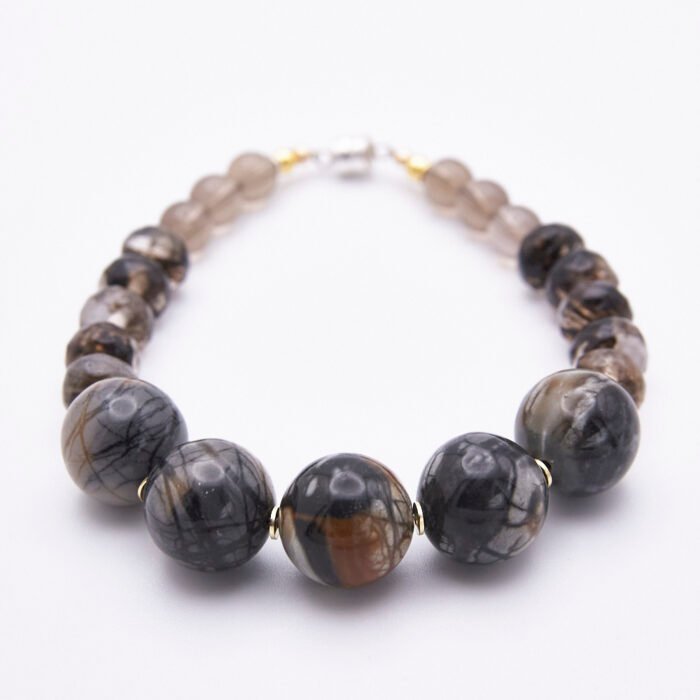 Picasso Jasper, Smoky Quartz and Smoky Watermelon Quartz Mixed Metals Bracelet with magnetic clasp shown with focus on Picasso Jasper beads on flat white surface