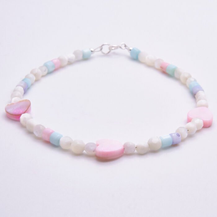 Mother of Pearl Heart Trio Bracelet shown on flat white surface with side-on view